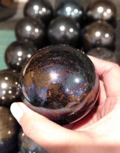 End stages of transforming rocks into polished sphere